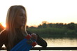 © mettus - Blond hair woman posing in front of sunset on waterfront with a lot of copyspace