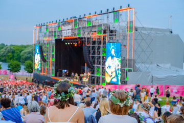 Wall Mural - Women are watching concert at open air music festival