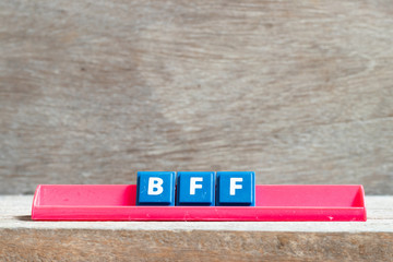 tile letter on red rack in word bff (abbreviation of best friend forever) on wood background