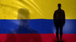 Colombian soldier silhouette standing against national flag, proud army sergeant