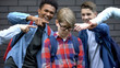 Evil schoolchildren pointing fingers at junior boy, mocking nerd, bullying