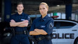 © motortion - Qualified police officers posing on background of patrol car, criminal justice