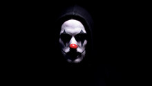 Spooky Clown In Hoodie Looking At Camera, Black Background, Criminal Disguise
