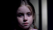 © motortion - Little crying girl looking at camera, victim of domestic violence, childs rights