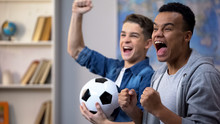 Emotional Multiracial Teenage Friends Cheering For National Soccer Team, Fans