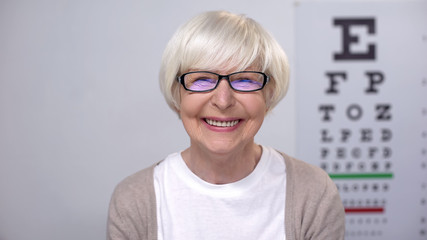 Smiling aged woman looking at camera, medical support for retired people