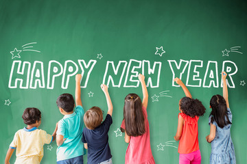 Wall Mural - school children drawing happy new year on the chalkboard