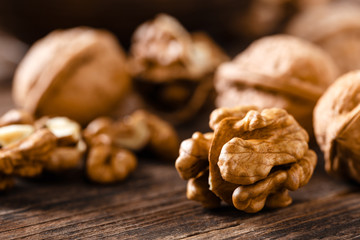 Poster - Walnuts. Kernels and whole nuts on wooden rustic table