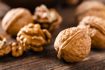 Sticker - Walnuts. Kernels and whole nuts on wooden rustic table