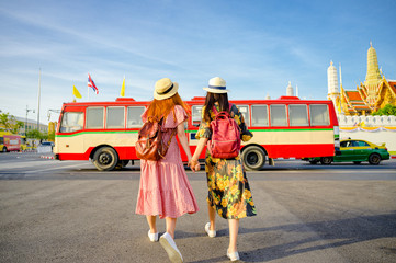 tourist women are going to get in Bus in Bangkok, traveling in urban bus city visit capital of Thailand