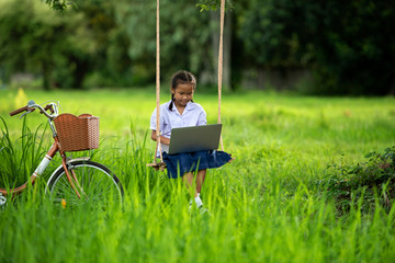 Wall Mural - Girls are learning by learning online with laptops in rural areas of Thailand.