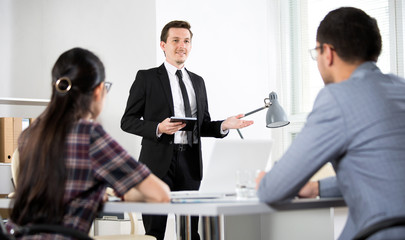 Wall Mural - Businessman tells his colleagues about a new project