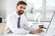 © chagin - Portrait of businessman working in an office