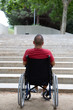 © Fabio - Person in a wheelchair in front of a stair.