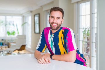 Wall Mural - Handsome man wearing colorful shirt and smiling positive at the camera