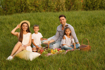 Canvas Print - Happy family having picnic in park on summer day