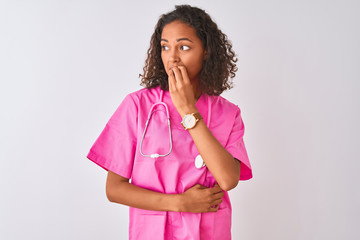 Poster - Young brazilian nurse woman wearing stethoscope standing over isolated white background looking stressed and nervous with hands on mouth biting nails. Anxiety problem.