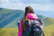 © Андрей Репетий - Traveling girl with backpack admiring the beauty of nature looking into the distance