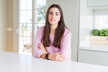 Poster - Beautiful young woman wearing pink sweater Relaxed with serious expression on face. Simple and natural looking at the camera.