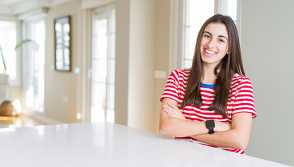 Poster - Beautiful young woman wearing casual stripes t-shirt happy face smiling with crossed arms looking at the camera. Positive person.