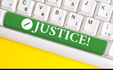 Writing note showing Justice. Business concept for impartial adjustment of conflicting claims or assignments White pc keyboard with note paper above the white background