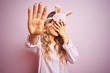 © Krakenimages.com - Young beautiful woman wearing pajama and sleep mask over pink isolated background covering eyes with hands and doing stop gesture with sad and fear expression. Embarrassed and negative concept.