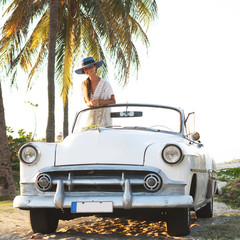 Poster - Happy young woman and retro convertible car