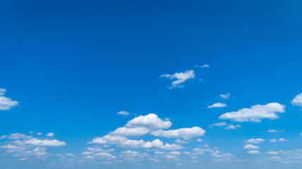 Wall Mural - White Clouds Floating in the Bright Blue Skies