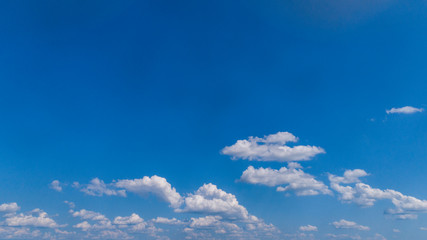 Wall Mural - White Clouds Floating in the Bright Blue Skies