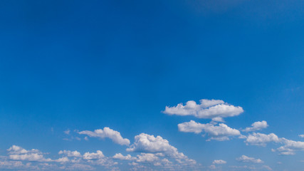 Wall Mural - White Clouds Floating in the Bright Blue Skies