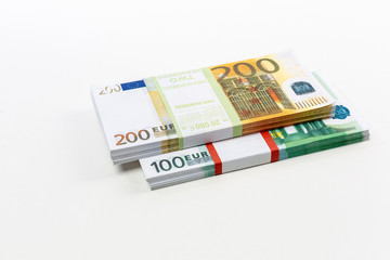 Euro cash in bundles of one hundred and two hundred banknotes, Euro money Euro on a white background, isolated on a white background