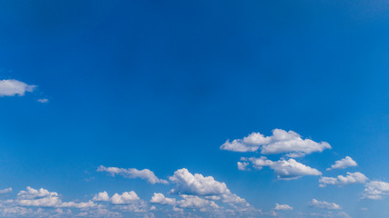 Wall Mural - White Clouds Floating in the Bright Blue Skies