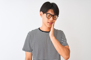 Sticker - Chinese man wearing glasses and navy striped t-shirt standing over isolated white background touching mouth with hand with painful expression because of toothache or dental illness on teeth