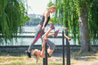 © okskukuruza - mother and daughter are exercising fitness equipment at the park