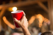 © Crystal Madsen - Woman's hand holding up red solo cup in cheer