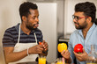 © liliyabatyrova - Two men using laptop in kitchen