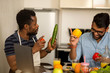 © liliyabatyrova - Two man using laptop in kitchen