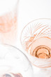 Sparkling rose wine in different glasses on white background