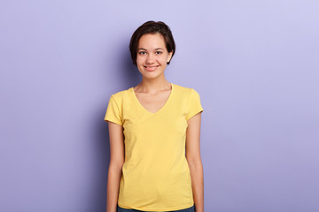 beautiful female student looking at the camera. close up photo. youth, people, isolated violet background