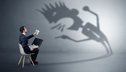 Wall Mural - Young businessman staying and negotiate with a monster shadow