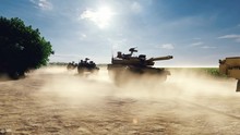 Military Tanks Ride On A Dusty Road On A Sunny Day On The Battlefield.