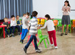 © JackF - Kids and teacher playing musical chairs