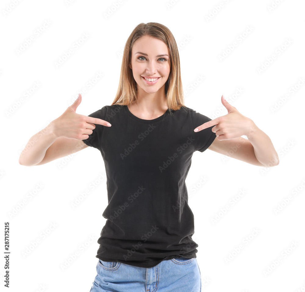 Woman pointing at her t-shirt against white background