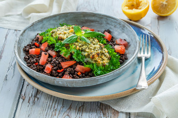 Canvas Print - Pesto-crusted cod with Puy lentils and tomatoes in a bowl