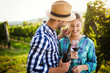 © NDABCREATIVITY - Woman and man in vineyard drinking wine