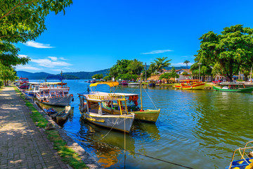 Fototapete - Embankment of historical center with boats in Paraty, Rio de Janeiro, Brazil. Paraty is a preserved Portuguese colonial and Brazilian Imperial municipality