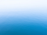 Fototapeta Desenie - Unique blue background. Blue sea water surface texture background with white copy space on top.