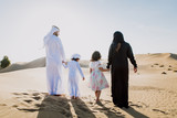 Fototapeta Kosmos - Arabian family spending a weekend in the desert, in Dubai