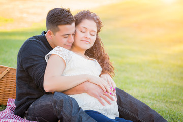 Wall Mural - Hispanic Pregnant Young Couple Portrait Outdoors