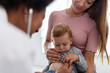 © lordn - Mother and her baby, visiting the doctor for a medical examination. Pediatrician doing an infant medical exam listening with a stethoscope.